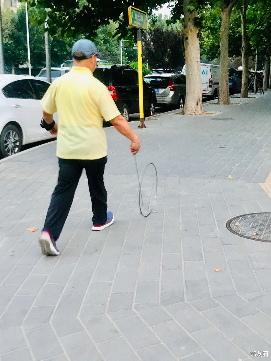 看见街边有人推铁环，现在比较少见了，小时候男孩子常玩的游戏。 - 邻友圈